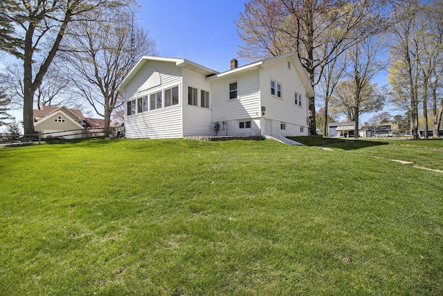 7034 W Dewey Rd, Ludington, MI 49431 - back of house with a chimney