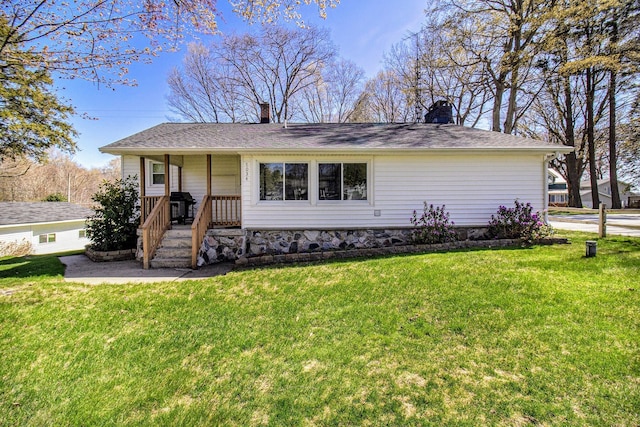 7034 W Dewey Rd, Ludington, MI 49431 - ranch-style house featuring a chimney, a front lawn, and covered porch