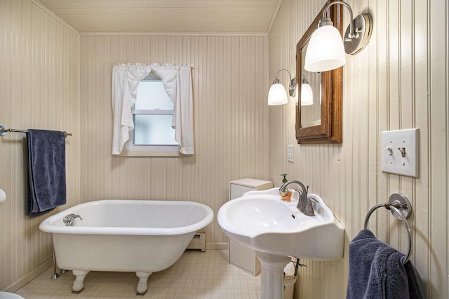 7034 W Dewey Rd, Ludington, MI 49431 - bathroom featuring a soaking tub, baseboards, ornamental molding, and a baseboard radiator
