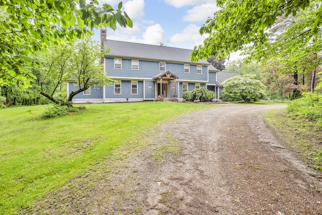 5340 Squires Manor Rd, Jackson, MI 49201 - colonial home with a chimney, driveway, and a front yard