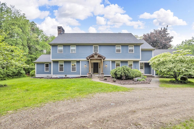 5340 Squires Manor Rd, Jackson, MI 49201 - colonial home featuring a chimney and a front yard