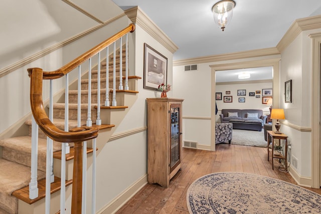 5340 Squires Manor Rd, Jackson, MI 49201 - stairway with wood-type flooring, baseboards, and ornamental molding