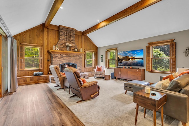 5340 Squires Manor Rd, Jackson, MI 49201 - living area featuring wood walls, plenty of natural light, wood finished floors, and a brick fireplace