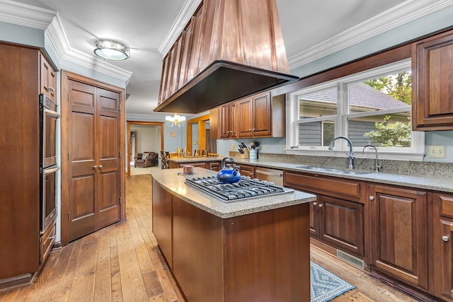 5340 Squires Manor Rd, Jackson, MI 49201 - kitchen featuring a sink, appliances with stainless steel finishes, light wood-type flooring, a center island, and ornamental molding