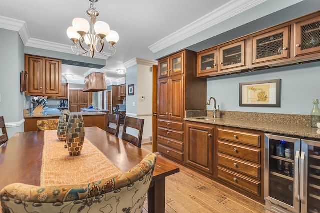 5340 Squires Manor Rd, Jackson, MI 49201 - dining space featuring beverage cooler, light wood-type flooring, crown molding, a chandelier, and bar area
