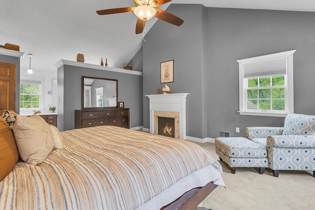 5340 Squires Manor Rd, Jackson, MI 49201 - carpeted bedroom with a lit fireplace, high vaulted ceiling, ceiling fan, and baseboards