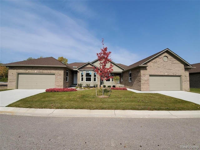ranch-style house with driveway, a garage, and a front yard