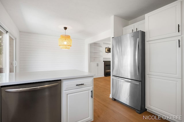 7745 Worthing Ct SW, Byron Center, MI 49315 - kitchen featuring stainless steel appliances, white cabinetry, light countertops, and light wood-style floors