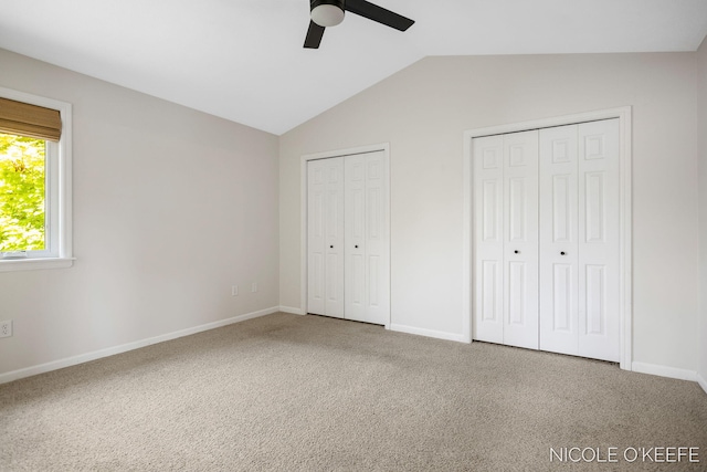 7745 Worthing Ct SW, Byron Center, MI 49315 - unfurnished bedroom with vaulted ceiling, two closets, carpet, and ceiling fan