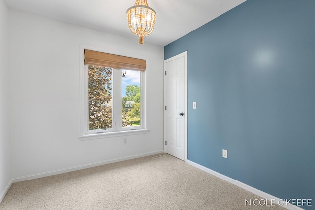 7745 Worthing Ct SW, Byron Center, MI 49315 - spare room featuring a chandelier and carpet flooring