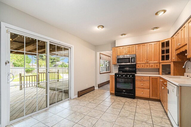 823 W Park Dr, Niles, MI 49120 - kitchen featuring black gas range, a sink, stainless steel microwave, white dishwasher, and baseboard heating