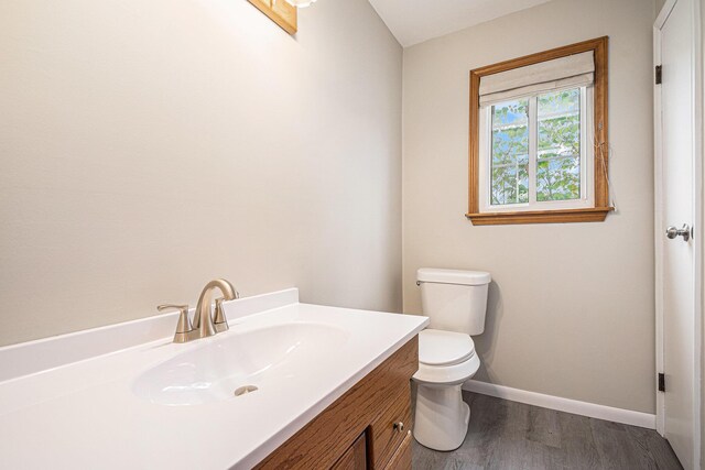 823 W Park Dr, Niles, MI 49120 - bathroom featuring baseboards, wood finished floors, toilet, and vanity