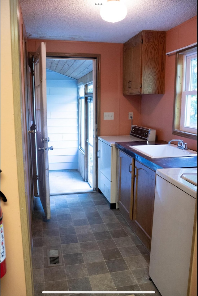 6340 Warren Woods Rd, Three Oaks, MI 49128 - laundry room featuring cabinet space, independent washer and dryer, and a textured ceiling