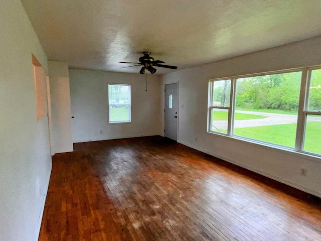 70025 Union Rd, Union, MI 49130 - unfurnished living room featuring hardwood / wood-style flooring, a ceiling fan, and baseboards