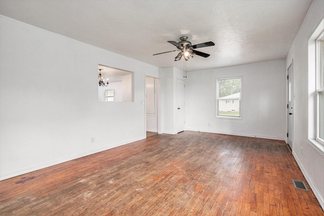 70025 Union Rd, Union, MI 49130 - spare room featuring a chandelier, wood-type flooring, ceiling fan, and baseboards