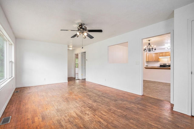 70025 Union Rd, Union, MI 49130 - empty room with a chandelier, wood finished floors, ceiling fan, and baseboards