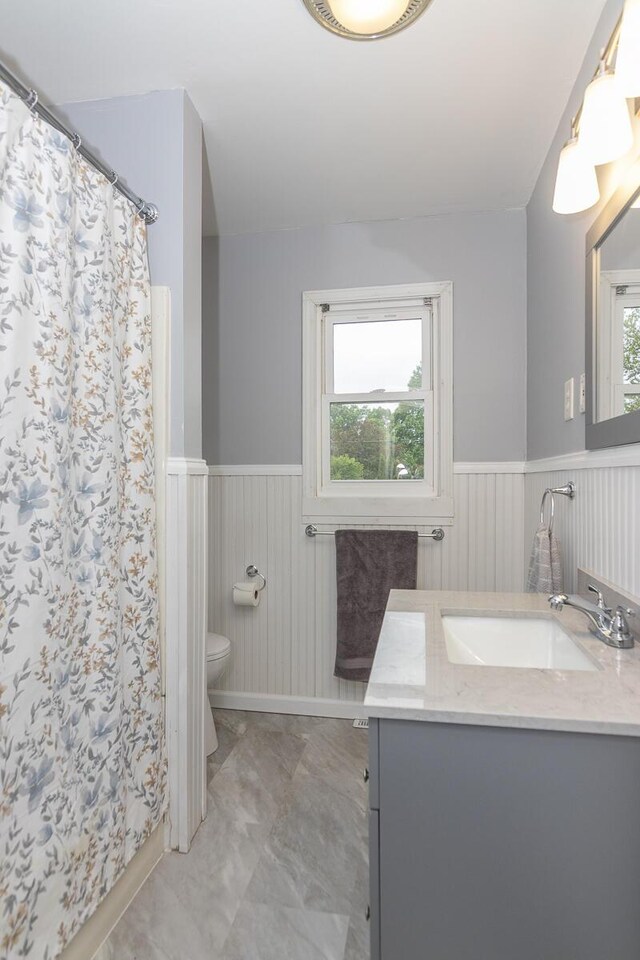 455 N Centre St, Schoolcraft, MI 49087 - bathroom featuring a wainscoted wall, toilet, vanity, marble finish floors, and a shower with curtain