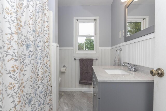455 N Centre St, Schoolcraft, MI 49087 - full bath featuring a wainscoted wall, toilet, vanity, marble look tile flooring, and a shower with shower curtain