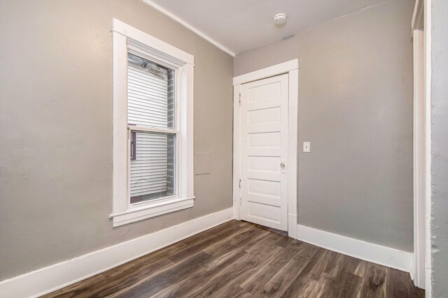 407 11th St NW Unit 409, Grand Rapids, MI 49504 - unfurnished room with dark wood finished floors, baseboards, and a smoke detector