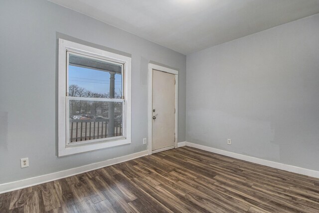 407 11th St NW Unit 409, Grand Rapids, MI 49504 - spare room featuring baseboards and dark wood-style floors