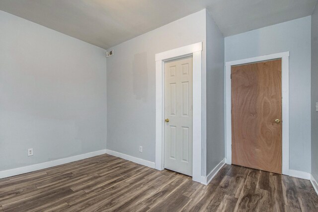 407 11th St NW Unit 409, Grand Rapids, MI 49504 - spare room with dark wood-type flooring and baseboards