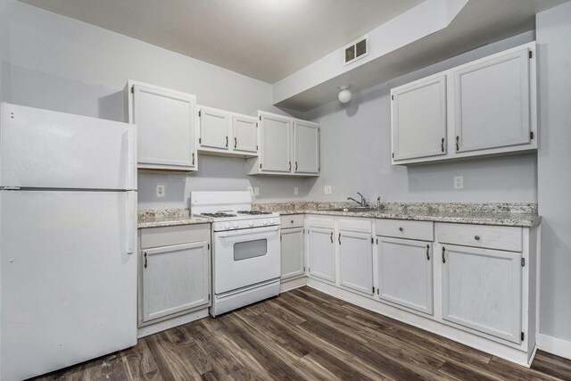 407 11th St NW Unit 409, Grand Rapids, MI 49504 - kitchen with white appliances, dark wood-style flooring, a sink, and white cabinetry