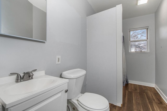 407 11th St NW Unit 409, Grand Rapids, MI 49504 - bathroom with toilet, wood finished floors, vanity, and baseboards