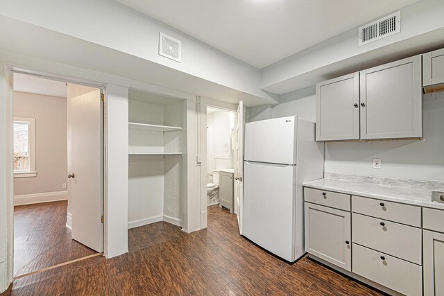 407 11th St NW Unit 409, Grand Rapids, MI 49504 - kitchen with freestanding refrigerator, dark wood-style floors, light countertops, baseboards, and gray cabinets