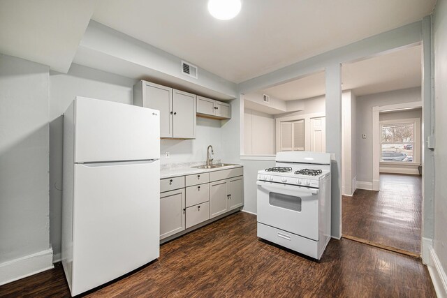 407 11th St NW Unit 409, Grand Rapids, MI 49504 - kitchen featuring white appliances, dark wood-style floors, a sink, baseboards, and light countertops