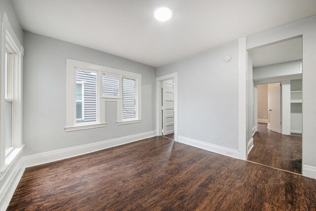 407 11th St NW Unit 409, Grand Rapids, MI 49504 - unfurnished bedroom with wood finished floors and baseboards