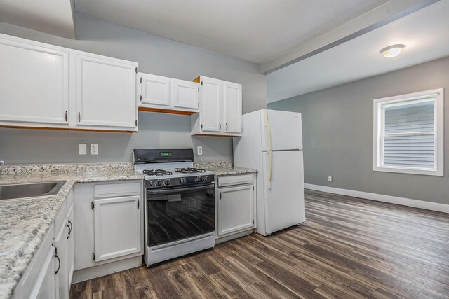 407 11th St NW Unit 409, Grand Rapids, MI 49504 - kitchen featuring gas range, freestanding refrigerator, dark wood finished floors, and white cabinetry