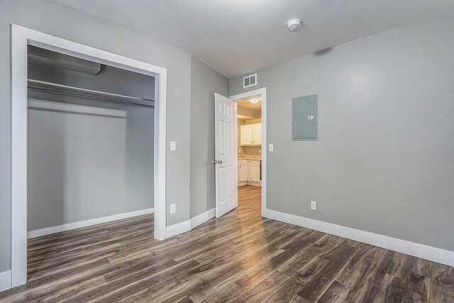 407 11th St NW Unit 409, Grand Rapids, MI 49504 - unfurnished bedroom with electric panel, wood finished floors, baseboards, and a closet