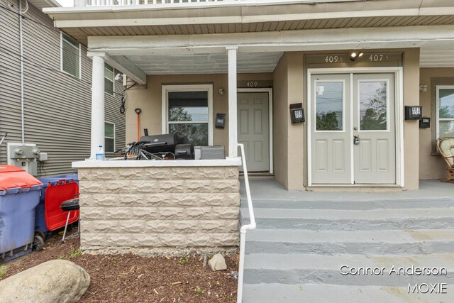 407 11th St NW Unit 409, Grand Rapids, MI 49504 - entrance to property with stucco siding and covered porch