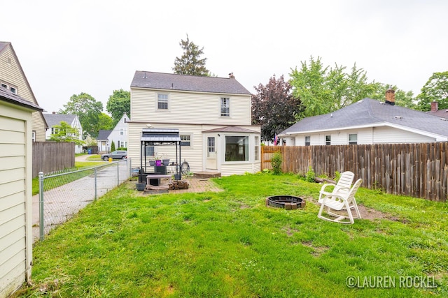 839 Joslin St SE, Grand Rapids, MI 49507 - rear view of property with a fire pit and a patio area