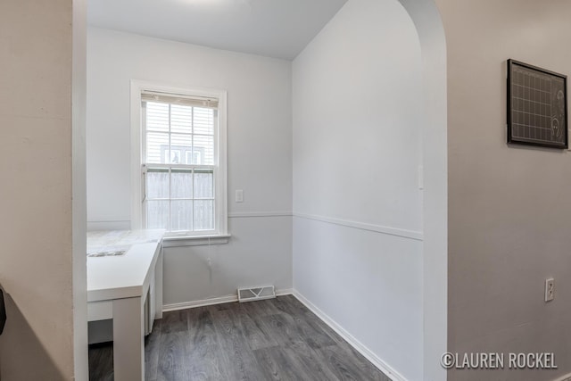 839 Joslin St SE, Grand Rapids, MI 49507 - washroom with dark wood-type flooring, arched walkways, and baseboards