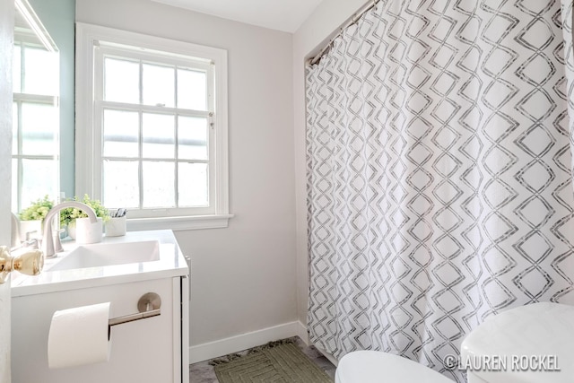 839 Joslin St SE, Grand Rapids, MI 49507 - bathroom with toilet, vanity, baseboards, and healthy amount of natural light