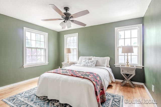 839 Joslin St SE, Grand Rapids, MI 49507 - bedroom featuring wood finished floors, baseboards, and a ceiling fan
