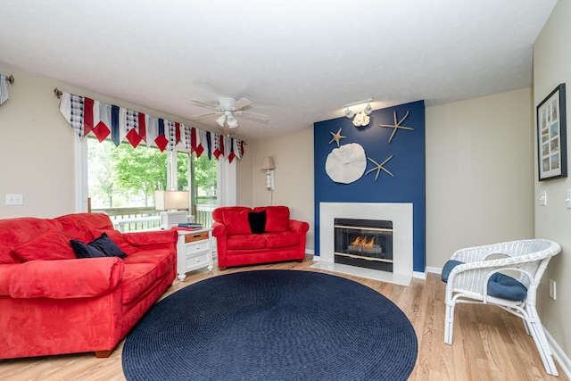 5632 N Watervliet Rd Unit 22, Watervliet, MI 49098 - living room with a fireplace with flush hearth, wood finished floors, and a ceiling fan