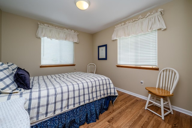 5632 N Watervliet Rd Unit 22, Watervliet, MI 49098 - bedroom featuring wood finished floors, multiple windows, and baseboards