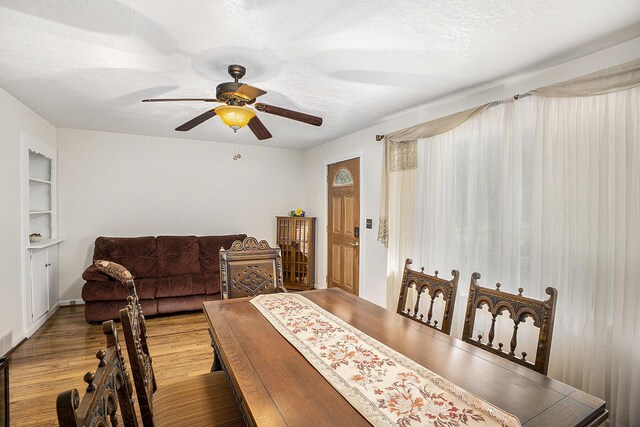 11713 Rountree Rd, Hanover, MI 49241 - dining area with a ceiling fan, wood finished floors, and a textured ceiling