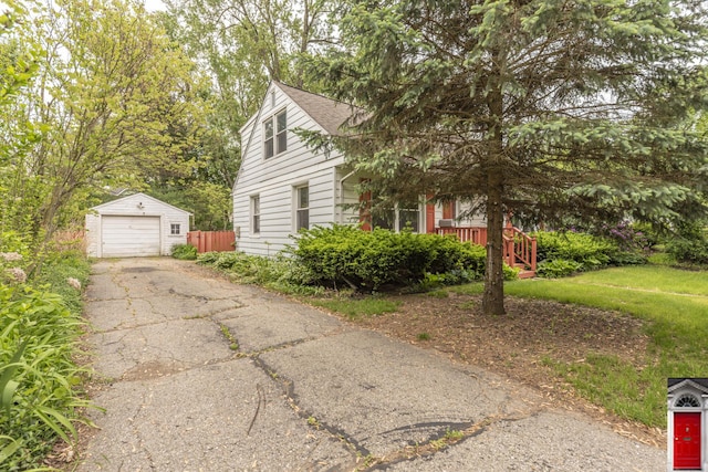 1506 Chandler Rd, Ann Arbor, MI 48105 - view of side of property featuring an outbuilding, asphalt driveway, and a detached garage