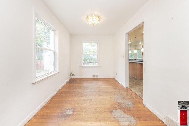 1506 Chandler Rd, Ann Arbor, MI 48105 - unfurnished dining area with light wood finished floors and baseboards