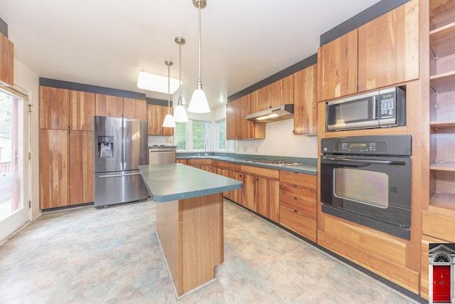 1506 Chandler Rd, Ann Arbor, MI 48105 - kitchen featuring appliances with stainless steel finishes, under cabinet range hood, dark countertops, and a kitchen island