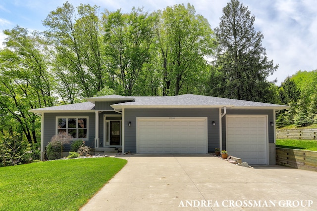 17946 Robbins Rd, Grand Haven, MI 49417 - view of front of property with concrete driveway, an attached garage, a front yard, and roof with shingles