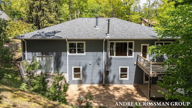 17946 Robbins Rd, Grand Haven, MI 49417 - rear view of property with a shingled roof, a wooden deck, and a chimney