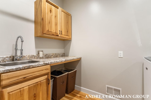 17946 Robbins Rd, Grand Haven, MI 49417 - kitchen featuring a sink, light wood-type flooring, light countertops, and baseboards