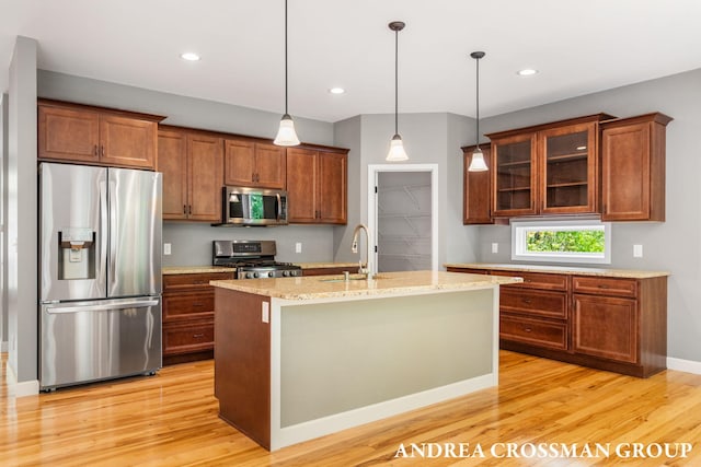 17946 Robbins Rd, Grand Haven, MI 49417 - kitchen with stainless steel appliances, a sink, light wood-style flooring, pendant lighting, and recessed lighting