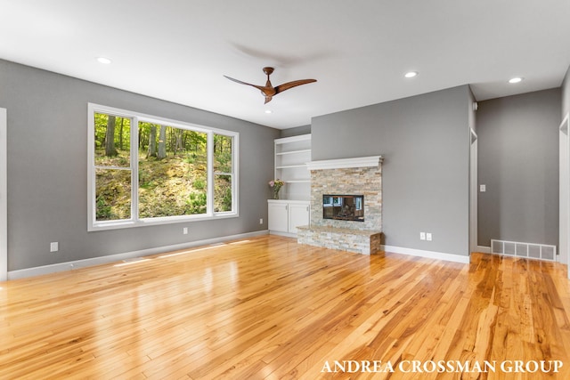 17946 Robbins Rd, Grand Haven, MI 49417 - unfurnished living room featuring wood-type flooring, a ceiling fan, recessed lighting, baseboards, and a fireplace