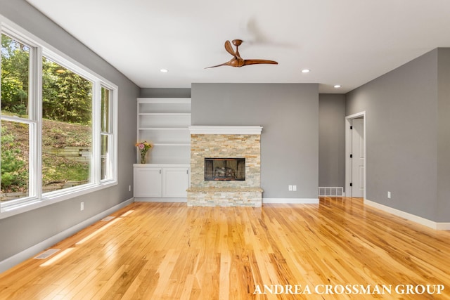 17946 Robbins Rd, Grand Haven, MI 49417 - unfurnished living room featuring light wood-style flooring, plenty of natural light, ceiling fan, a fireplace, and recessed lighting