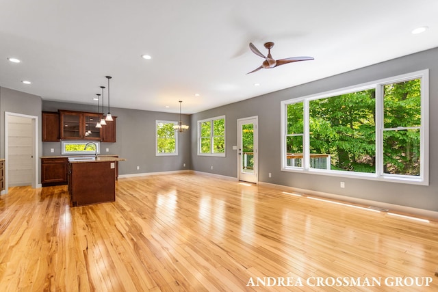 17946 Robbins Rd, Grand Haven, MI 49417 - unfurnished living room featuring a sink, light wood-type flooring, a ceiling fan, recessed lighting, and baseboards